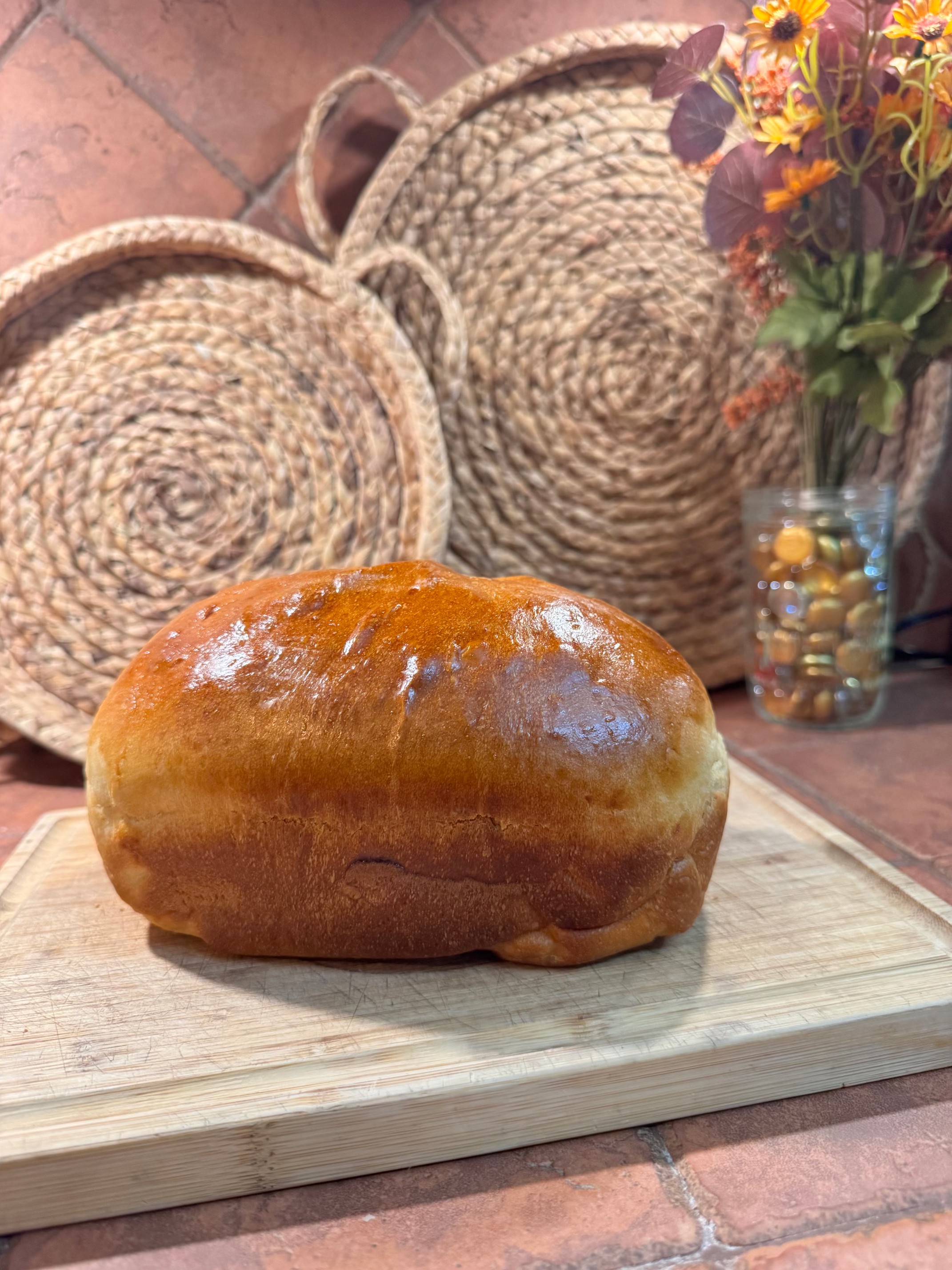 Glossy golden loaf brushed with honey butter, fresh from the oven